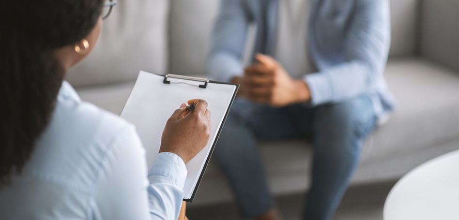 A therapist and a client engaged in a PTSD support session at Prodigy Clinic